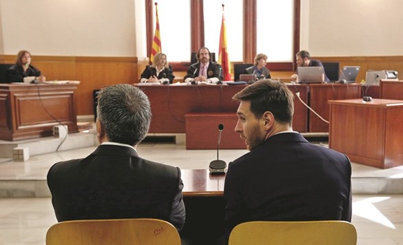 In this June 2, 2016, picture, Lionel Messi (right) and his father Jorge face judges in a tax fraud case at the courthouse of Barcelona. (AFP)
