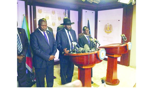 South Sudan President Salva Kiir, flanked by former rebel leader Riek Machar (left) and other government officials, addresses a news conference in Juba, South Sudan yesterday.