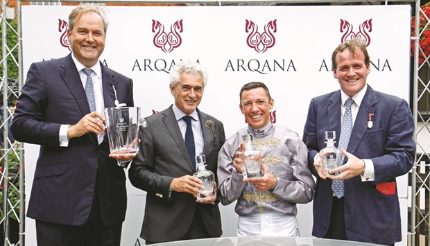 Al Shaqabu2019s Racing manager Harry Herbert (left), jockey Frankie Dettori (second from right) and trainer Richard Hannon (right) pose with their trophies after Mehmas won the Arqana July Stakes at Newmarket on Thursday. (Racingfotos)