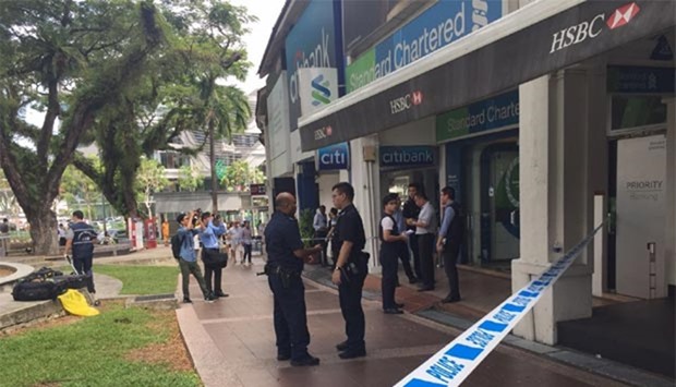 Singapore police are seen outside the Standard Chartered branch