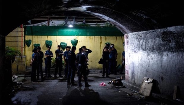Police investigate after finding the body of an alleged drug dealer in Manila.