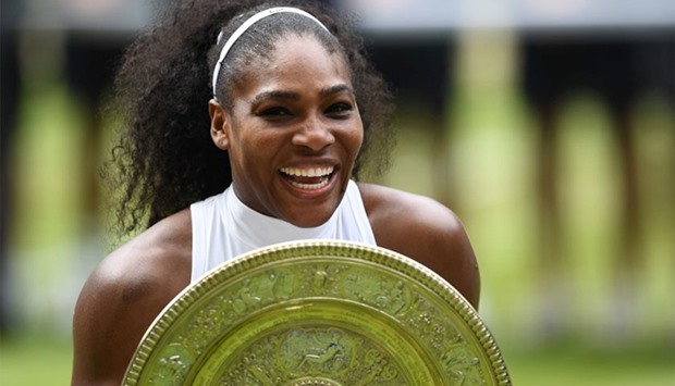US player Serena Williams poses with the winner's trophy, the Venus Rosewater Dish, after her women's singles final victory over Germany's Angelique Kerber.