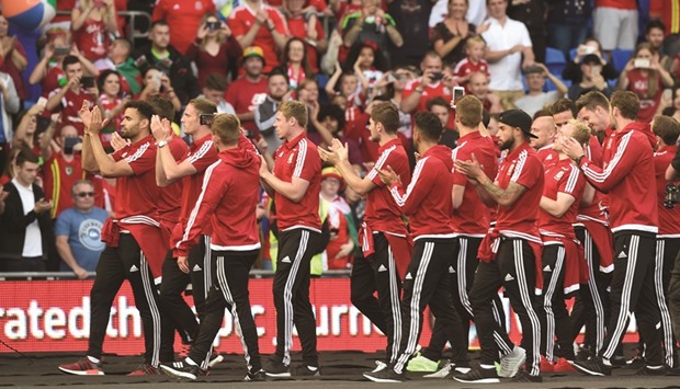 Wales players applaud fans at Cardiff Stadium after their return from Euro Championships on Friday. Wales lost to Portugal in the semi-finals. (Reuters)
