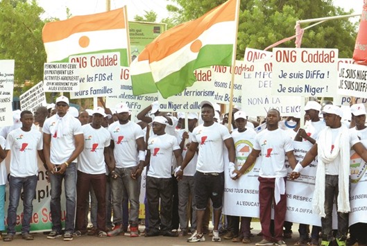 People holding hands as they took part in a march against Islamist group Boko Haram yesterday in Niamey.