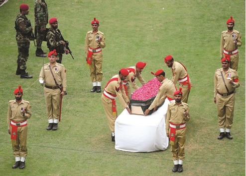 Pakistani soldiers place the coffin of renowned social worker Abdul Sattar Edhi during his funeral ceremony in Karachi yesterday.A gloomy Pakistan yesterday bade farewell to its national hero Abdul Sattar Edhi, the founder of the countryu2019s largest welfare organisation who died on Friday in Karachi aged 88.