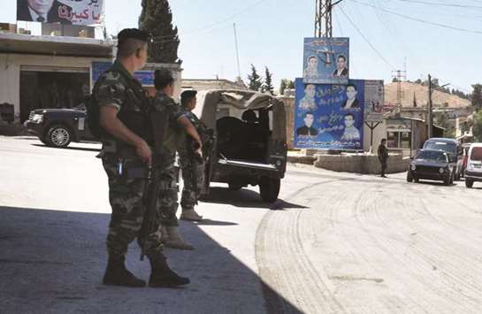 Lebanese army soldiers patrol a street at the entrance of the border town of Arsal, in eastern Bekaa Valley, yesterday.