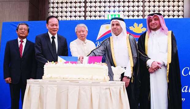 HE Mohamed Abdul Wahed Ali al-Hammadi (second, right) and ambassador Alan Timbayan (centre) lead the ceremonial cutting of cake at the Philippine Independence Day reception on Sunday. They were joined by Ministry of Foreign Affairsu2019 Chief of Protocol Ibrahim Yousif Abdullah Fakhro (right) and two Asean ambassadors. PICTURE: Imelda Enrile