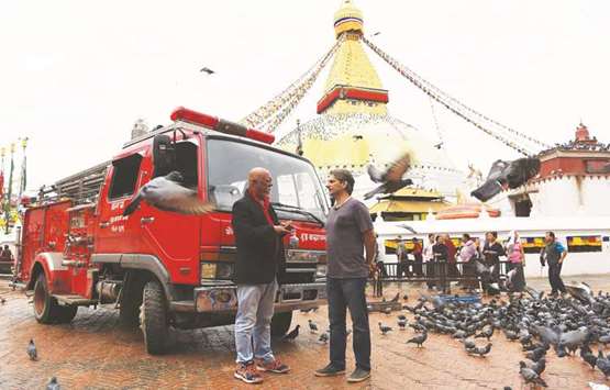 Michael Imperioli and Nepali Bollywood star Sunil Thapa, left, talk at the Boudhanath Stupa in Kathmandu yesterday.