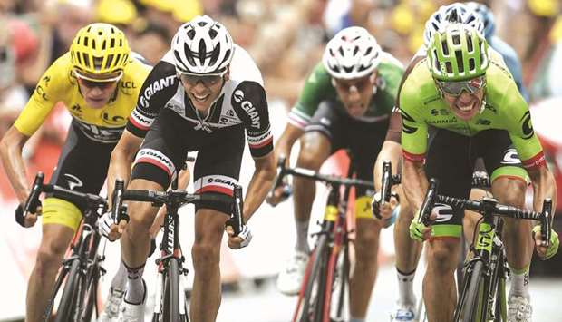 Colombiau2019s Rigoberto Uran (right) sprints to win ahead of Great Britainu2019s Christopher Froome (left) wearing the overall leaderu2019s yellow jersey, Franceu2019s Warren Barguil (2nd left) and Italyu2019s Fabio Aru (2nd right) at the finish line at the end of the 181,5km ninth stage of the 104th edition of the Tour de France. (AFP)