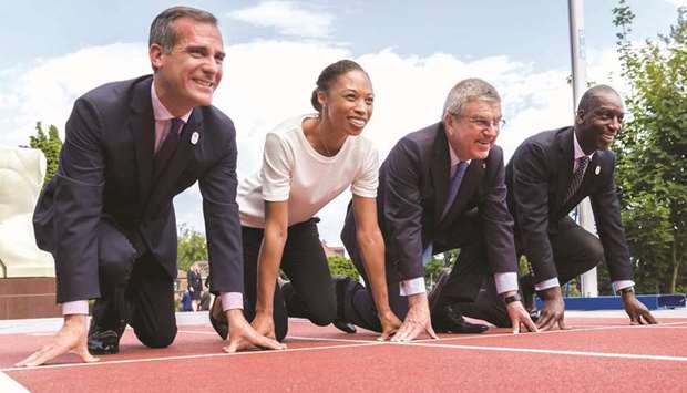 (left to right) Los Angeles Mayor Eric Garcetti, US Olympic track and field athlete Allyson Felix, International Olympic Committee (IOC) President German Thomas Bach and former US Olympic track and field athlete Michael Johnson pose during a visit to the Olympic Museum on the eve of their bid presentation before the International Olympic Committee (IOC) members in Lausanne yesterday. (AFP)