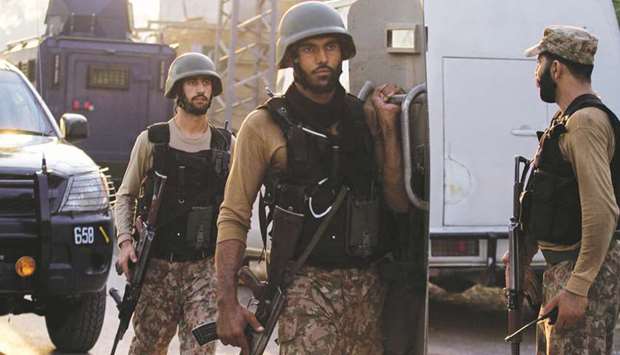 Soldiers return to the staging area after participating in a security operation on the outskirts of Peshawar.