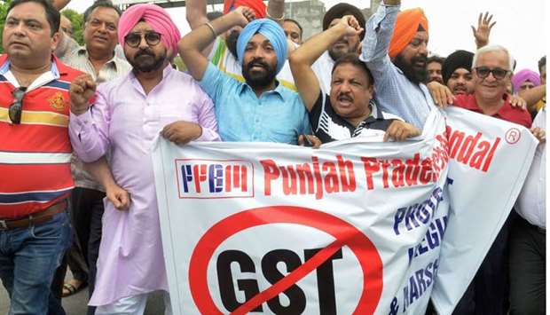 Indian traders protesting against the forthcoming Goods and Services Tax (GST) during a demonstration outside a tax office in Amritsar yesterday.  AFP