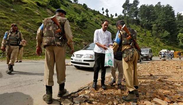 An Indian security force personnel checks the bag of a man near a base camp of Hindu pilgrimage to the cave of Amarnath after seven Hindu pilgrims were killed in a gunbattle between Indian police and militants in Langanbal village in south Kashmir's Anantnag district, on Tuesday.