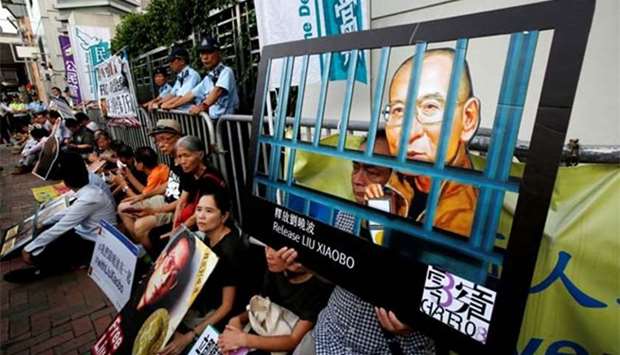 Pro-democracy activists stage a sit-in protest demanding the release of Nobel laureate Liu Xiaobo, outside China's Liaison Office in Hong Kong on Monday.