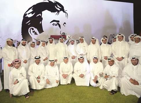 HE Sheikh Abdulrahman bin Hamad al-Thani along with journalists and media professionals attending the unveiling of the u2018Tamim Al Majdu2019 mural at the QMC headquarters yesterday.