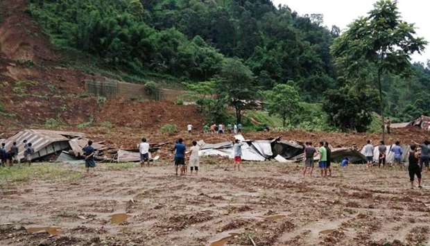 Indian villagers look on during a rescue operation at the site of a landslide in Laptap village in the Papum Pare district of the state of Arunachal Pradesh.
