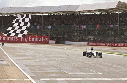 This file photo shows Mercedes AMG Petronas F1 Teamu2019s British driver Lewis Hamilton crossing the finish line to win the British Formula One Grand Prix at Silverstone.