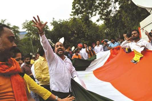 Students from the Akhil Bharatiya Vidyarthi Parishad (ABVP), the student wing of the Bharatiya Janata Party (BJP), shout slogans as they carry Indiau2019s national flag during a protest against the Khanabal terror attack in New Delhi yesterday.