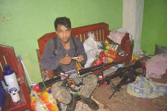 This undated handout photo shows a militant member of the so-called Maute group, inside a house in Marawi.