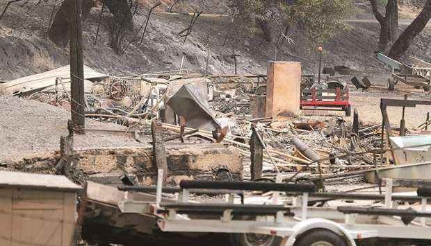 The remains of a structure and boats scorched by the Whittier Fire along SR-154 in the Los Padres National Forest near Lake Cachuma, Santa Barbara County on Sunday. At least 200 people were evacuated from a remote area east of Santa Maria. Wildfires continued to rage across California amid a record-breaking heatwave.