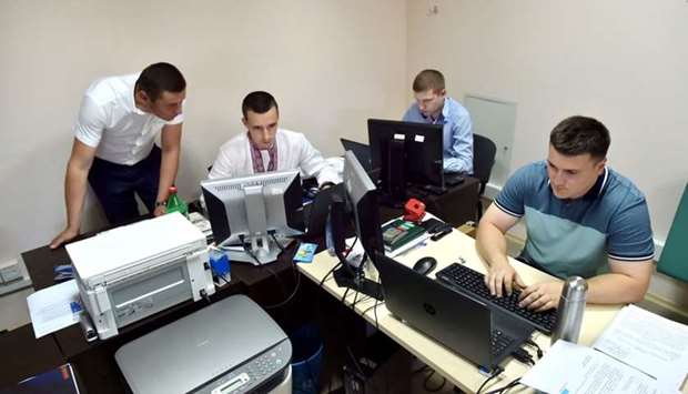 Officers of Ukrainian Cyberpolice Department work in an office in the department building in Kiev on June 29, 2017. AFP