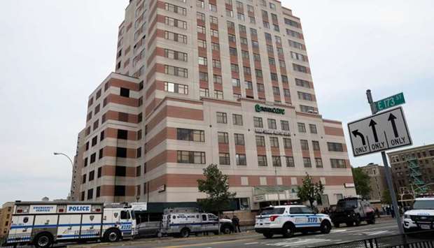 NYPD officers work outside Bronx-Lebanon Hospital, after an incident in which a gunman fired shots inside the hospital, in New York City.