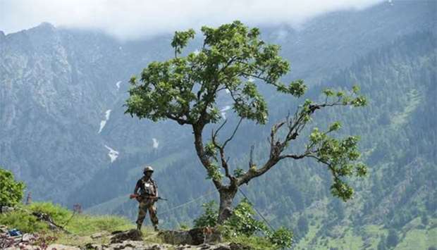 An Indian Border Security Force soldier stands guard on top of a hill in Chandanwari in Anantnag district during the annual Hindu pilgrimage to the Amarnath shrine cave.