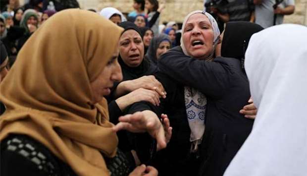 Relatives mourn during the funeral of Palestinian Mohammad Jebril in Tekoa village near the West Bank city of Bethlehem on Tuesday.