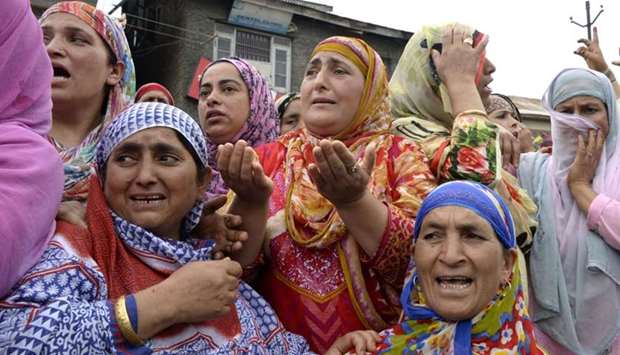 Indian Kashmiri women watch the funeral of slain rebel Aaquib Gul after a gunfight between rebels and Indian government forces in central kashmir's Budgam district in Srinagar on July 12, 2017
