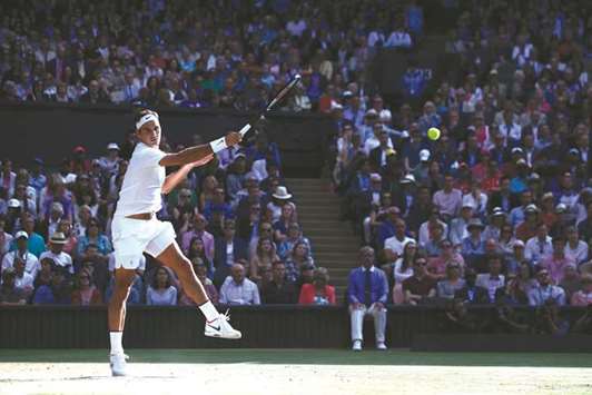Switzerlandu2019s Roger Federer returns against Canadau2019s Milos Raonic during their menu2019s  singles quarter-final match on the ninth day of the 2017 Wimbledon Championships at  The All England Lawn Tennis Club in Wimbledon yesterday.