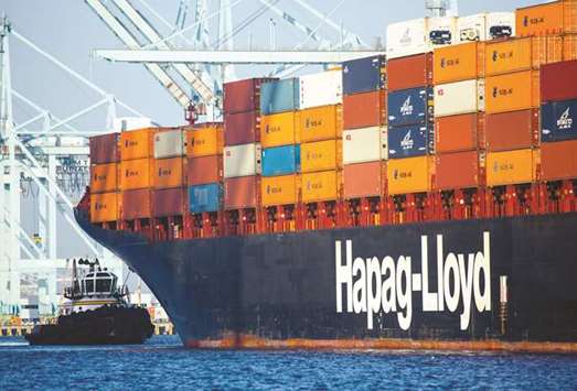 A tug boat moves into position behind a Hapag-Lloyd container ship at the Port of Los Angeles. The German shipper boosted its sale of seven-year bonds last week to u20ac450mn from a planned u20ac300mn, and lowered the yield to 5.125% from about 5.25%.