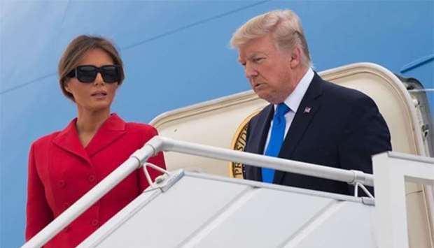 US President Donald Trump and First Lady Melania Trump disembark form Air Force One upon arrival at Paris Orly airport on Thursday.
