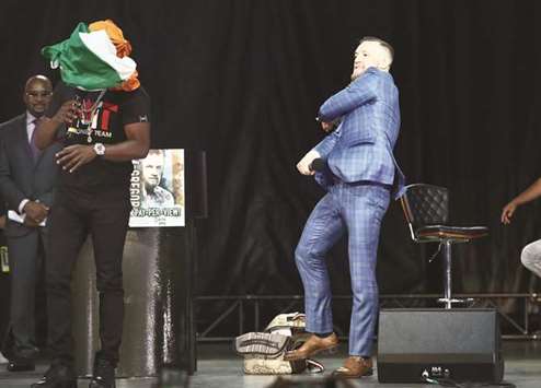 Conor McGregor throws an Irish flag at Floyd Mayweather as he speaks during a world tour press conference to promote their upcoming fight at Budweiser Stage in Toronto. PICTURE: USA TODAY Sports
