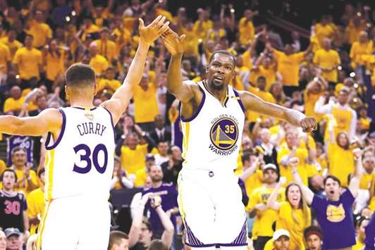 Weu2019ll still win it: Stephen Curry (left) and Kevin Durant of the Golden State Warriors react during Game 2 of the 2017 NBA Finals against Cleveland Cavaliers.