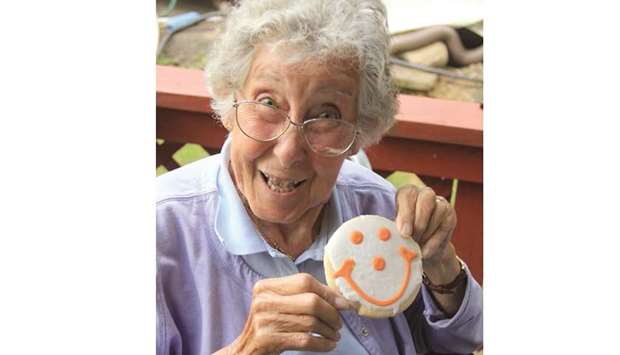 SAYING IT WITH A SMILE: Norma Bauerschmidt shows a creamed cookie with a smiley topping.