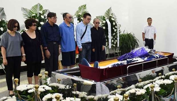 Nobel laureate Liu Xiaobo's wife Liu Xia (right in black) and family members standing next to Liu Xiaobo's body at a funeral parlour in the Chinese city of Shenyang on Saturday.