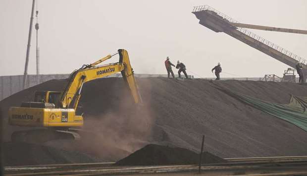 Labourers work on a pile of iron ore at a steel factory in China. The volume of Chinese imports of North Korean iron ore nearly doubled in the first five months of 2017 compared to the same period last year, according to Bloomberg Intelligence.