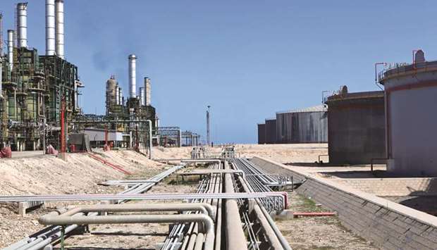 Refining towers and fuel storage tanks are seen at the Zawiya oil refinery near Tripoli (file). A ministerial committee from Opec and non-Opec countries meets in Russia on July 24 to discuss compliance with the production cuts, from which Nigeria and Libya are exempt.