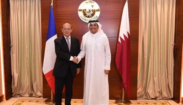 HE the Foreign Minister Sheikh Mohamed bin Abdulrahman al-Thani shakes hands with French Minister of Foreign Affairs Jean-Yves Le Drian