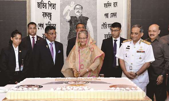 Prime Minister Sheikh Hasina cutting a cake on the occasion of the 31st founding anniversary of the Special Security Force (SSF) in Dhaka yesterday.