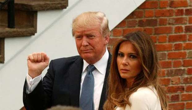 President Donald Trump and First Lady Melania Trump arrive for dinner at Trump National Golf Club in Bedminster, New Jersey, on Friday.