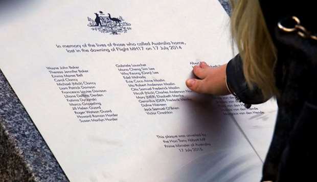 A relative of an Australian victim of Malaysia Airlines jet MH17 touches a memorial that was unveiled outside Parliament House in Canberra, Australia, July 17