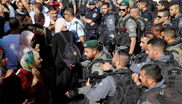 A Palestinian woman argues with an Israeli border policeman at the entrance to the compound known to Muslims as Noble Sanctuary in Jerusalem.