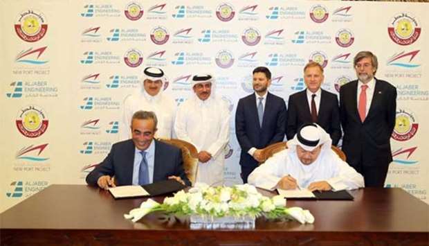 New Port Project executive director Maisar Jamil el-Qutami and Al Jaber Engineering CEO Osama Hadid sign the agreement during a ceremony held at the MoTC headquarters on Sunday. Looking on are HE the Minister of Transport and Communications Jassim Seif Ahmed al-Sulaiti, Swiss ambassador Etienne Thevoz, German ambassador Hans-Udo Muzel, and Italian ambassador Pasquale Salzano. PICTURE: Nasar TK