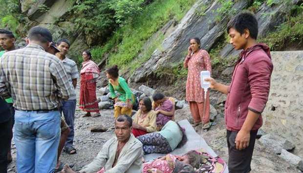 People wait for relief after being displaced by flood in Khani Khola and other rivulets in Khimti Bazaar of Ramechhap district on July 16, 2017. Photo courtesy: Himalayan Times