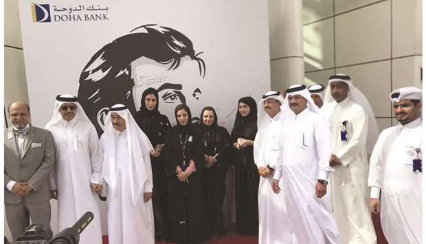 Doha Bank officials in front of the mural.