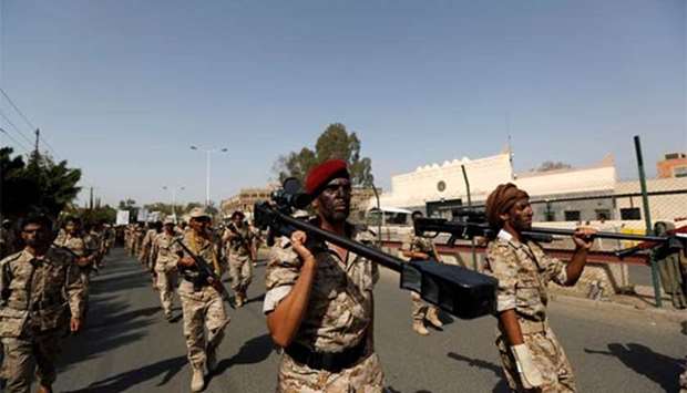 Newly recruited fighters parade outside the US embassy before they join Houthi rebels, in the Yemeni capital Sanaa on Monday.