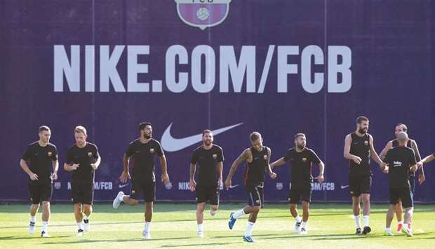 Barcelona players warm up during a training session in Barcelona, Spain, yesterday. (Reuters)