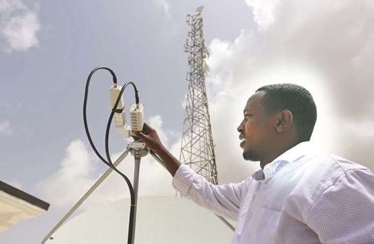 A Somali Optical Networks (SOON) technician checks a satellite dish at their headquarters in Mogadishu.