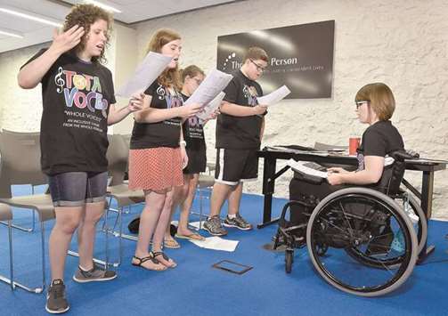Tota Voceu2019s director, Heather Schouten, right, herself paraplegic, leads the rehearsal with members Amanda Plachecki of Liberty, from left, Nikki Sanders of Platte City, and Katie Roell and Scottie Bledsoe of Weatherby Lake at The Whole Person.